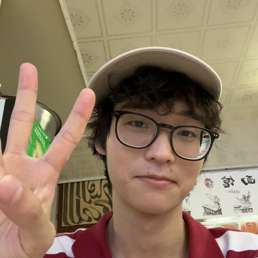 a portrait of a guy with curly hair wearing a white cap with fingers making a peace sign
